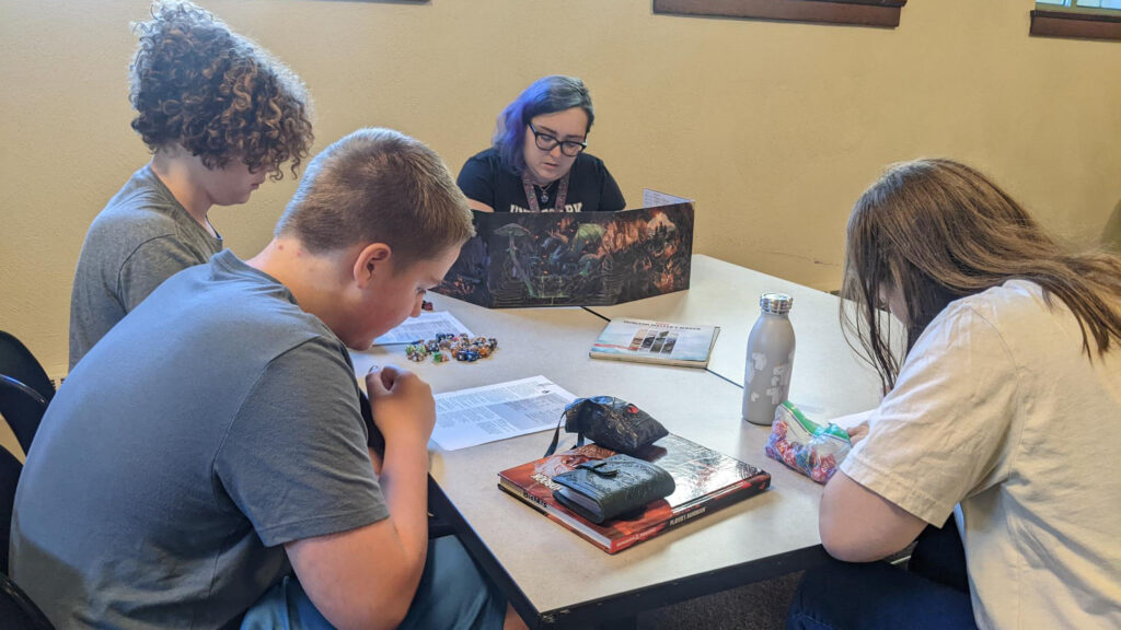 Graduate Student, Alexa Justice, teaches philosophy in her role as Game Master playing Dungeons and Dragons (D&D) at Westwood Public Library